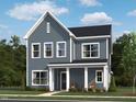 Charming two-story home with inviting porch, surrounded by lush greenery and landscaping at 261 Marvel Dr # 136, Rolesville, NC 27571