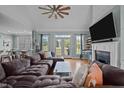 Comfortable living room features hardwood floors, fireplace, large windows and neutral walls at 281 Derwin Dr, Timberlake, NC 27583