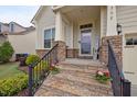 Close-up of the front steps leading to the entrance with stone accents and a welcoming sign at 302 Kinney Glenn Ct, Durham, NC 27713