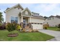Attractive home with stone accents, a neat lawn, and an attached two-car garage at 302 Kinney Glenn Ct, Durham, NC 27713