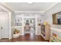 Open entryway leading to the dining area featuring hardwood floors and decorative columns at 311 Pate St, Apex, NC 27502