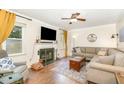 Cozy living room with a fireplace, large windows, and comfortable seating arrangements at 311 Pate St, Apex, NC 27502