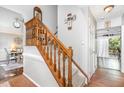 Elegant staircase with wooden banister, carpeted steps and neutral wall paint at 311 Pate St, Apex, NC 27502