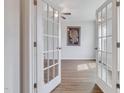 Bright room with French doors, ceiling fan, and wood-look flooring at 316 Alice Trace Place, Angier, NC 27501