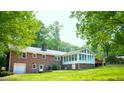 Brick home with enclosed sunroom, patio and spacious backyard at 3204 Manor Ridge Dr, Raleigh, NC 27603