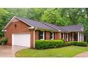 Brick home with a two-car garage and well-maintained landscaping at 3204 Manor Ridge Dr, Raleigh, NC 27603