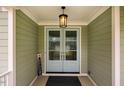 Stylish light blue front door with glass panels and an overhead light fixture for a welcoming entrance at 328 Boone St, Chapel Hill, NC 27516