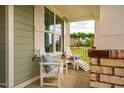 Cozy front porch showcasing comfortable white chairs and a view of the surrounding neighborhood at 328 Boone St, Chapel Hill, NC 27516