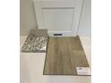 Sample of white cabinets, light backsplash, granite countertop and luxury vinyl plank flooring at 368 Chesapeak Commons St # 132, Garner, NC 27529