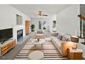 Bright living room with fireplace, ceiling fan, and neutral decor, staged with modern furniture at 3708 Mackinac Island Ln, Raleigh, NC 27610