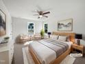 Sun-filled main bedroom with neutral tones, a ceiling fan, and stylish modern decor at 3708 Mackinac Island Ln, Raleigh, NC 27610