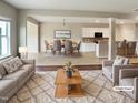 Bright, open-concept living space with modern decor flowing into the dining area and kitchen at 3709 Althorp Dr, Raleigh, NC 27616