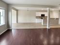 Open concept living space with tile floor and view of the kitchen with white cabinets at 3709 Althorp Dr, Raleigh, NC 27616