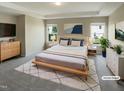 Bright main bedroom with a tray ceiling, neutral decor, and a large window for ample natural light at 3709 Althorp Dr, Raleigh, NC 27616