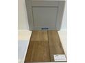 Displaying Stone Gray cabinets with luxury vinyl Heardesville Plus Driftwood flooring samples at 376 Chesapeak Commons St # 130, Garner, NC 27529