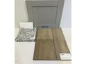 Sample of interior finishes featuring gray cabinet, granite countertop, and wood-look luxury vinyl flooring at 376 Chesapeak Commons St # 130, Garner, NC 27529