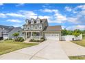 Beautiful two-story house featuring an attached garage and long driveway at 384 Grey Hawk Dr, Garner, NC 27529