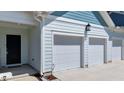 The front entrance features a covered porch with a welcoming entry and a spacious three-car garage at 412 Kavanaugh Rd, Wake Forest, NC 27587