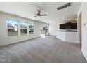 Spacious living room with great natural light, neutral carpeting, and seamless flow to the kitchen at 4169 Weavers Pond Dr, Zebulon, NC 27597