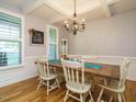 Elegant dining room with a large wooden table, chandelier, and stylish decor at 49 Mount Joy Pl, Sanford, NC 27330