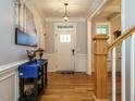 Open foyer with hardwood floors, staircase, decorative console table, and natural light at 49 Mount Joy Pl, Sanford, NC 27330