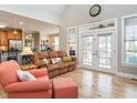 Bright living room with hardwood floors, a high ceiling, and direct access to the patio at 506 Wildwood Ln, Graham, NC 27253