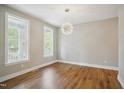 Cozy bedroom features wood floors, neutral walls, and natural light at 509 Olive Branch Rd, Durham, NC 27703