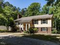 Charming two-story home with a well-manicured lawn, complemented by mature trees and a welcoming facade at 525 Turtle Creek Farm Rd, Apex, NC 27523