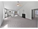 A spacious living area with vaulted ceilings, a cozy fireplace, and modern neutral carpeting at 5612 Tealbrook Dr, Raleigh, NC 27610