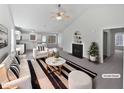 Open-concept living room with a fireplace, high ceilings, and seamlessly connected to the kitchen at 5612 Tealbrook Dr, Raleigh, NC 27610