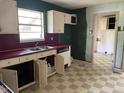 View of the kitchen with ample counter space, a double sink and updated appliances at 601 Crestview Dr, Durham, NC 27712
