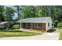 Well-maintained exterior showing the brick siding and manicured lawn at 612 Harvest Ln, Raleigh, NC 27606