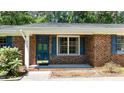 Close-up of front entrance with brick facade and blue door at 612 Harvest Ln, Raleigh, NC 27606