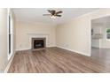 A living room featuring a brick fireplace, ceiling fan, and light-colored walls at 6225 Jones Farm Rd, Wake Forest, NC 27587