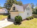 Rear exterior view of a well-kept home showing manicured lawn and an attached two-car garage at 6513 Cablewood Dr, Raleigh, NC 27603