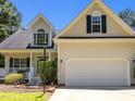 Attractive home featuring an attached two-car garage and welcoming front porch with well-maintained landscaping at 6513 Cablewood Dr, Raleigh, NC 27603