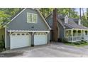 Exterior view of a home featuring a two-car garage and traditional architectural details at 6517 Hidden Pond Rd, Wendell, NC 27591