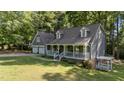 Charming home with a welcoming front porch and two-car garage nestled among lush greenery at 6517 Hidden Pond Rd, Wendell, NC 27591