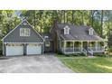 Charming home with a welcoming front porch and two-car garage nestled among lush greenery at 6517 Hidden Pond Rd, Wendell, NC 27591