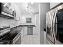 Updated kitchen features white cabinets, stainless appliances and stylish black marble countertops at 6565 New Market Way, Raleigh, NC 27615