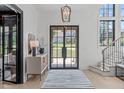 Bright foyer features large windows, stylish light fixtures, and elegant entryway details at 702 Wimbleton Dr, Raleigh, NC 27609
