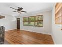 Bright living room boasts hardwood floors, ceiling fan, and views of the front yard at 717 Fairfield St, Burlington, NC 27215