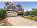 Charming two-story home with a spacious driveway, attached garage, and a well-manicured lawn at 7700 Stonehenge Farm Ln, Raleigh, NC 27613