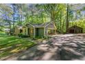 Charming home featuring a lush, wooded lot, a long driveway, and a detached garage at 8409 Crowder Rd, Raleigh, NC 27603