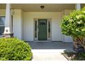 Inviting home entryway with a traditional door, sidelights, and manicured landscaping at 870 Kentucky Derby Ln, Lillington, NC 27546