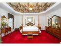 Luxurious main bedroom featuring a four-poster bed and cloud-patterned ceiling at 8733 Crowder Rd, Raleigh, NC 27603