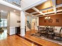 Spacious dining room with hardwood floors, coffered ceiling, and elegant chandelier at 91 E Walker Woods Ln, Clayton, NC 27527