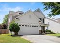 Side view of home highlighting the two-car garage and manicured lawn at 1005 Fulbright Dr, Morrisville, NC 27560