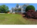 Inviting two-story home features a well-maintained lawn and classic architectural details at 1009 Open Field Dr, Garner, NC 27529