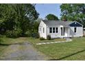 Well-maintained home with a white exterior, surrounded by a green lawn at 102 Allen St, Graham, NC 27253